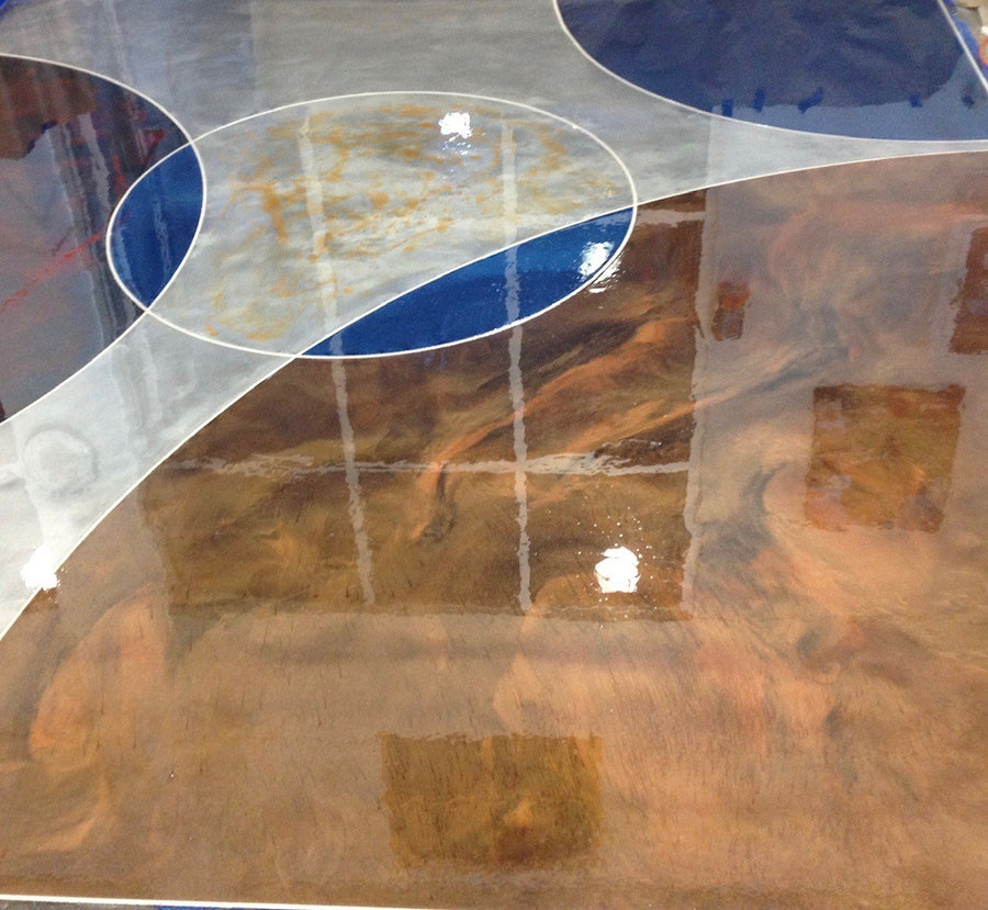 Copper, silver, and cobalt metallic epoxy floor with inlaid curved lines