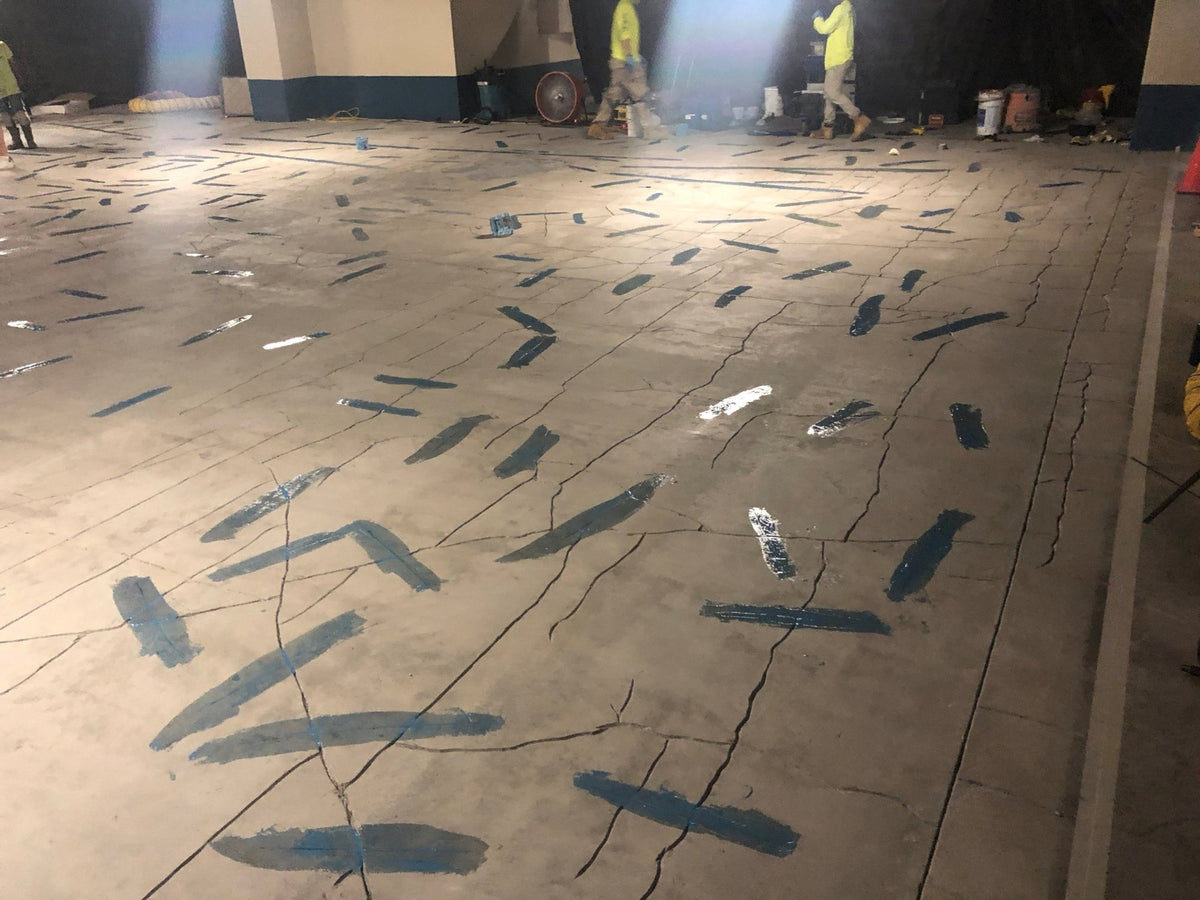 Hawaii parking structure slab with hundreds of StitchDog carbon fiber stitches installed across a network of cracks